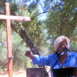 A woman is speaking at an outdoor event.