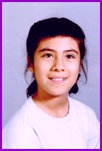 A young girl is smiling for the camera.